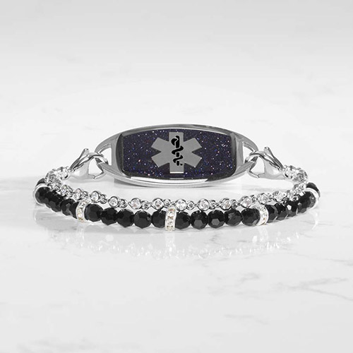 Close-up view of a two-strand medical ID bracelet featuring glossy black beads paired with clear crystals in bezel settings.
