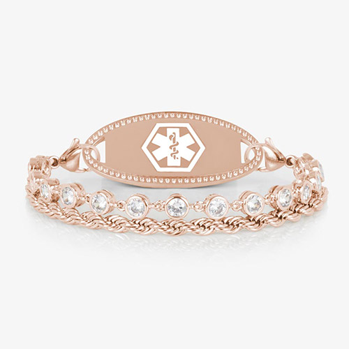 Rose gold medical ID bracelet featuring a clear CZ tennis strand paired with a twisted chain, shown with a polished rose gold ID tag engraved with the medical caduceus symbol.