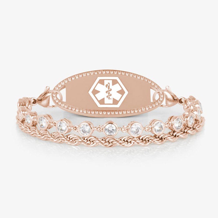 Rose gold medical ID bracelet featuring a clear CZ tennis strand paired with a twisted chain, shown with a polished rose gold ID tag engraved with the medical caduceus symbol.