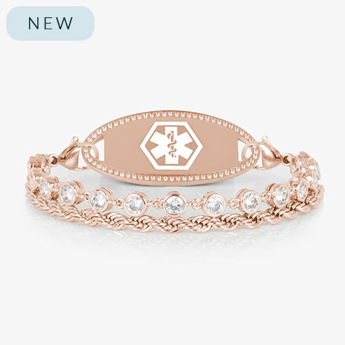 Rose gold medical ID bracelet featuring a clear CZ tennis strand paired with a twisted chain, shown with a polished rose gold ID tag engraved with the medical caduceus symbol.