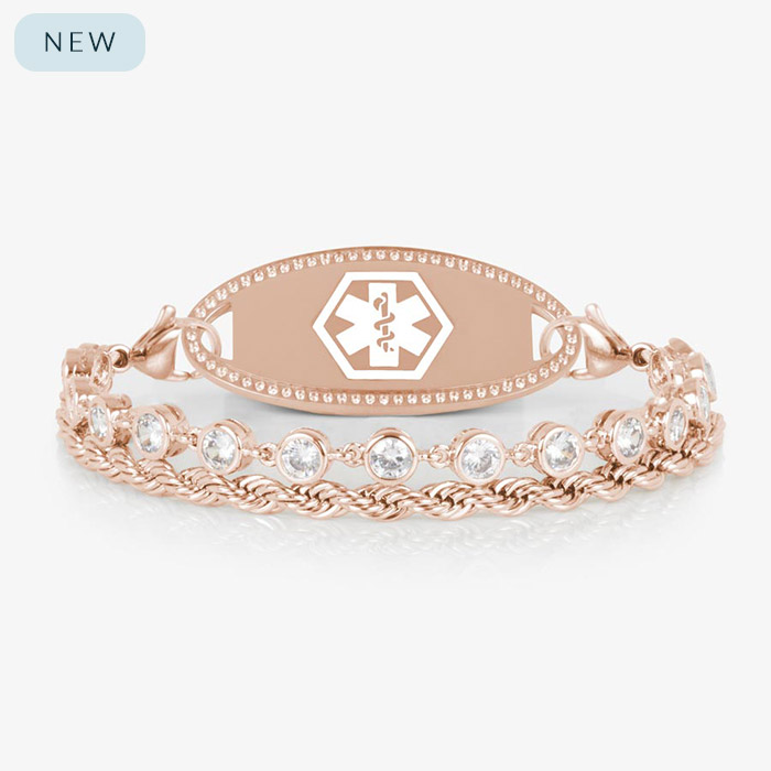 Rose gold medical ID bracelet featuring a clear CZ tennis strand paired with a twisted chain, shown with a polished rose gold ID tag engraved with the medical caduceus symbol.