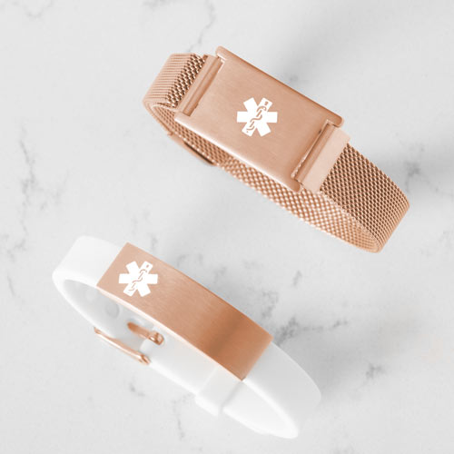 White and rose gold silicone medical ID bracelet stacked on top of rose gold medical alert with mesh band