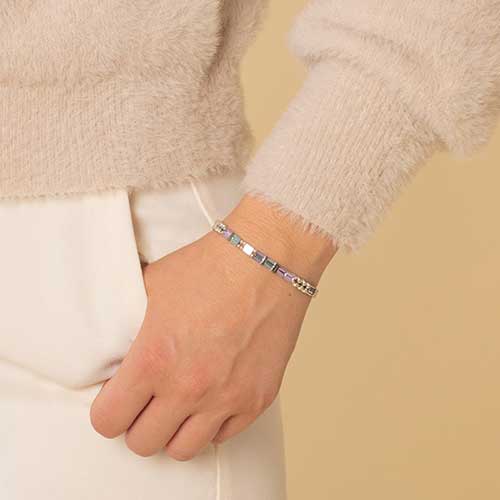 Woman wearing medical alert bracelet with flat pastel beads