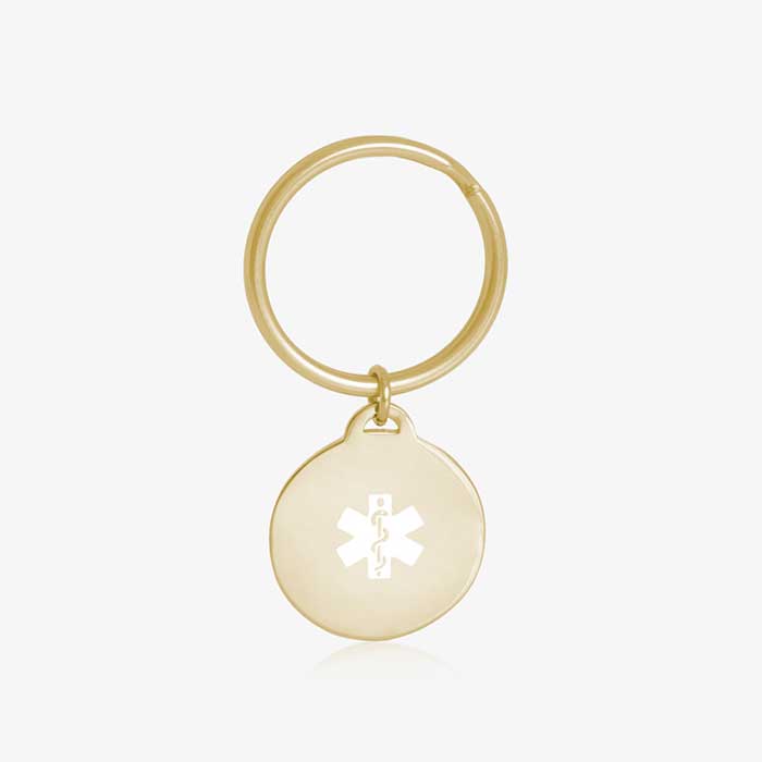 Key ID - gold tone circular charm with white medical caduceus symbol and gold keychain ring