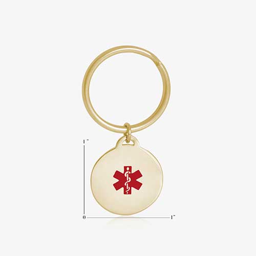 Key ID - gold tone circular charm with red medical caduceus symbol and gold keychain ring, showing charm measurements of one inch by one inch.
