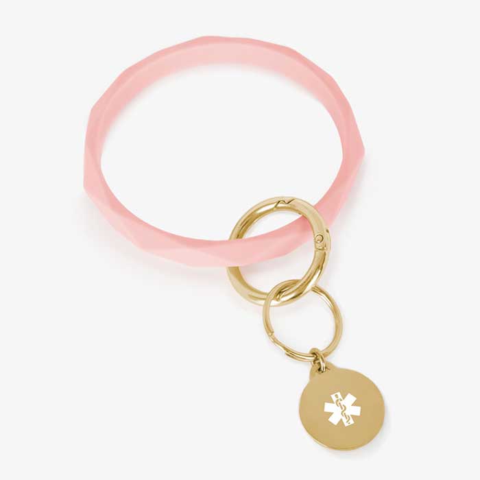 Soft pink faceted silicone medical ID key ring wristlet with gold tone stainless steel medical alert charm.