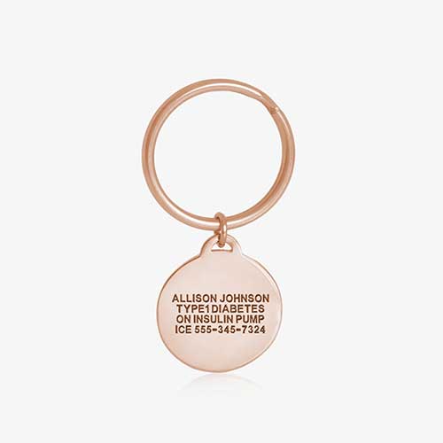Key ID - rose gold tone circular charm showing premium custom engraving on the back side